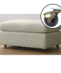 Heavy Duty Two Inch Swivel Caster Wheels For Vintage Furniture With Slick Brass Rolling Base and black wheel under an ottoman.