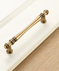 Slick Antique Brass Cabinet Pulls 10 Pack, 5 Inch Top Tier Solid Metal Drawer Handles For Kitchen Cabinets And Bathrooms, Smooth Grip Vintage Hardware Upgrade For Dressers And Home Projects, No Sweat Install Legit Craftsmanship showing close-up of brass handle.