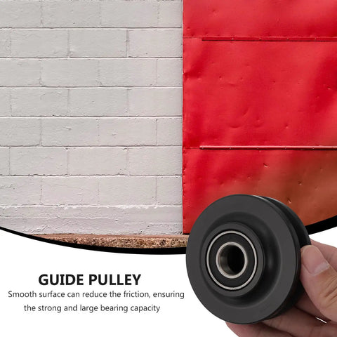 Heavy Duty Nylon Sliding Door Guide Wheel Pulley For Barn Door Track Systems, black pulley in hand with red barn door background.