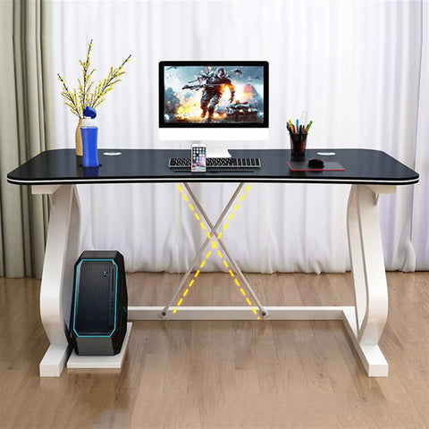Solid Multifunction Computer Desk With Nifty Cable Management Hole Ergonomic Arched Edge Compact Gaming Workstation Total Game Changer For Tiny Rooms Waterproof Black Surface 47 Inches Wide with computer and accessories.