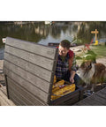 Man accessing Lockable 120 Gallon Outdoor Storage Deck Box For Patio Backyard And Garden In Brown Waterproof Plastic Bench