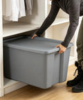 Heavy Duty 30 Gallon Plastic Storage Bin With A No Hassle Snap Closure Built Tough For Massive Household Items Plus Plenty Of Room For Seasonal Gear in gray being placed on a shelf.