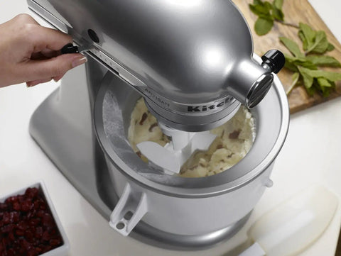 Hand using stand mixer ice cream maker attachment makes up to 2 quarts of ice cream gelato or sorbet in 20 to 30 minutes.