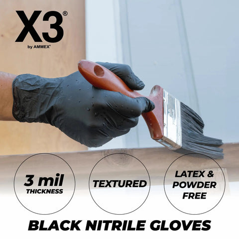 Person wearing Black Nitrile Disposable Gloves 3 Mil Powder Free Large for cooking and food prep, painting a wooden surface