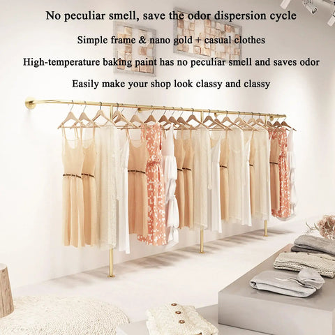 Top Tier Wall Mounted Garment Rack With Built In Shelves And Brushed Gold Finish Straight Ready For Any Boutique Or Master Closet Heavy Duty Metal Clothes Rail That Actually Holds Your Threads showcasing dresses in a boutique.
