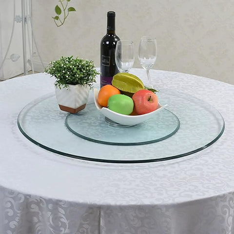 Smooth Operator 34 Inch Lazy Susan Turntable With Slick Tempered Glass Dining Table Insert featuring fruit and wine on a table.