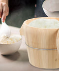 Top Shelf Hardwood Rice Steamer Basket With Tight Flat Lid For Easy Kitchen Prep, serving sticky rice from wooden bucket.