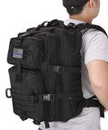 Person wearing MOLLE Assault Backpack 40L Tactical Military Rucksack 3 Day Pack With USA Flag Patch; side view