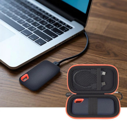 Hard Case For SanDisk Extreme Portable SSD Built Tough Rugged Foam Padding And Mesh Pocket For USB Cables And SD Cards Custom Fit External Drive Protector In Bright Orange Zipper next to laptop