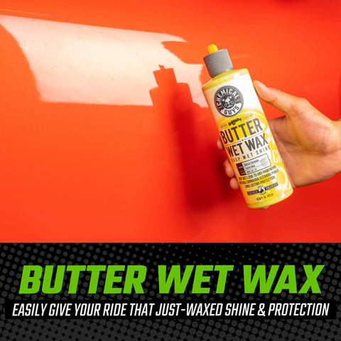 Hand holding Butter Wet Wax from 14 Piece Car Wash Arsenal Builder Kit with Foam Blaster Wash Bucket Towels Applicators and 16 oz soaps.