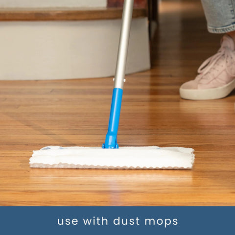 Flat mop with blue handle and white microfiber cleaning pad on wood floor