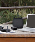 Slick Clutch Hard Shell Case For Travel Routers With Snug Mesh Pocket And Heavy Duty Zipper For Gl Mt3000 Gl Be3600 on a desk.