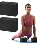 Kick Your Practice Up With This Game Changer Yoga Block Built From Lightweight EVA Foam With A Nonslip Grip And Rounded Beveled Edges That Keep You Balanced Through Pilates Vibes, featuring two black yoga blocks used by a woman.