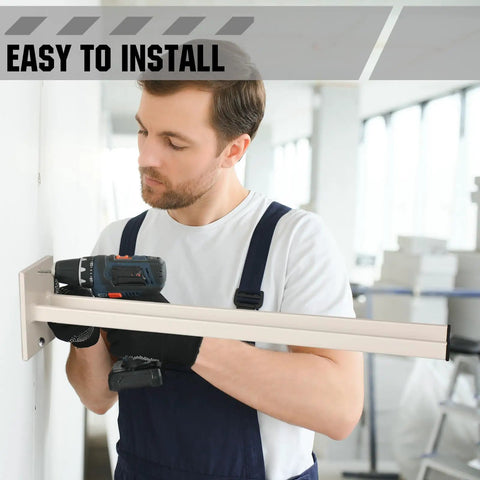 Real Deal Steel Shovel Holder Wall Mount 2 Pack With Extended Tines being installed on a wall by a man with a drill.
