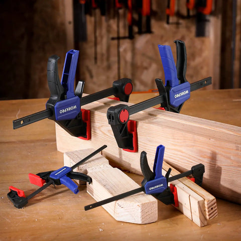 Go-To Mini Bar Clamp Set For Woodworking on wood block, includes two 4.5 inch and two 6 inch bar clamps in blue.