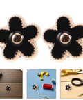 Close-up of Twenty Piece Black Flower Snap Buttons Slick Metal Clip On Fasteners for Apparel Repairs, stylish and functional.