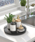 Rock Solid 12 Inch Black Oak Lazy Susan Turntable Tray holding soap bottles and a brush on a bathroom counter.