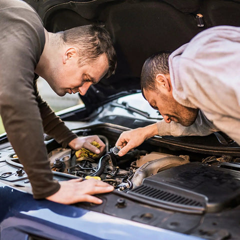Men working on engine, using Stainless Steel Internal Tooth Lock Washers Star Shaped Locking Washers Assortment Kit for secure fastening.