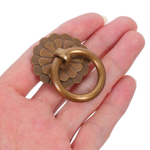 Close-up of a vintage-style brass ring pull handle, part of the Six Pack Vintage Style Brass Drawer Knobs and Ring Pull Handles Set for Cabinets.