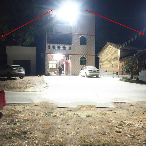 Hella Bright 10000W Solar Street Light With Remote Control IP65 Waterproof Dusk To Dawn Outdoor Flood Lamp illuminating a yard at night.