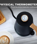 Top view of a black Gooseneck Electric Kettle With Built-In Thermometer, 1L Stainless Steel, next to a latte and croissant.