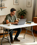 Man working at a laptop on a 6 Ft Folding Table Outdoor Indoor Plastic Square Dining Table Portable No Assembly Easy Setup