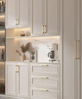 Modern kitchen with 10 Pack 4 Inch Brushed Gold Cabinet Pulls made from solid zinc alloy installed on white cabinets and drawers.