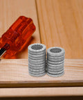 Twenty Piece M10 Wedge Stack Lock Washers Tough Heavy Manganese Steel Hardware Fasteners display next to a red screwdriver.