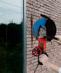14 Inch Electric Concrete Saw and Wall Grooving Machine with Slick Rolling Base cutting through brick, showing water spray for dust control.