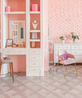 Stylish pink and white dressing room with modern decor and sleek storage solutions, featuring elegant furniture and floral accents.