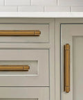 Straight Up Solid Zinc Alloy Cabinet Pulls With Vintage Backplate Antique Brass Drawer Handles on light gray cabinetry.