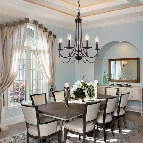 Five Light Farmhouse Chandelier In Black With Classic Candle Ceiling Light Fixture in a cozy dining room setting.