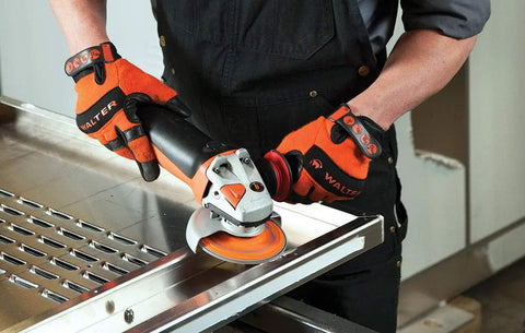 Worker using Enduro-Flex Stainless Flap Disc Ceramic Abrasive 4-1/2 Inch Diameter 7/8 Inch Arbor Grit 40 on metal surface