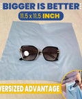 Front view: oversized black sunglasses on light blue microfiber cleaning cloth, 11.5 x 11.5 in