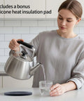 Person pouring from Whistling Stovetop Tea Kettle With Big Capacity And Fast Heat Technology Built With Thick Durable Body For All Cooktops Induction Compatible Professional Teapot For Quick Boil And Easy Pour