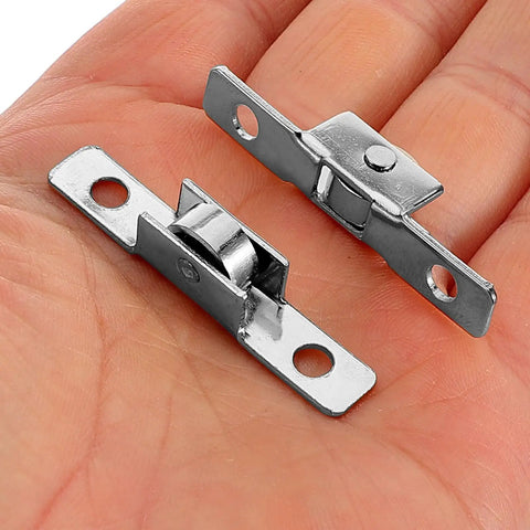 Ten Pack Heavy Duty Sliding Door Roller Wheels Featuring Sealed Double Bearings And Tough As Nails Iron Mounts For Buttery Smooth Silent Gliding Glass Doors Without The Hassle; close-up of roller wheels in hand.
