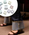 Invisible Leg Shortening Clips Portable No Sew Pants Adjusters Alloy Quick Fix Hem Clips shown on jeans with sandals.