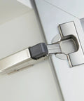 Smooth As Butter Soft Close Add Ons For Cabinet Doors, showing a steel hinge attachment on a kitchen cabinet.