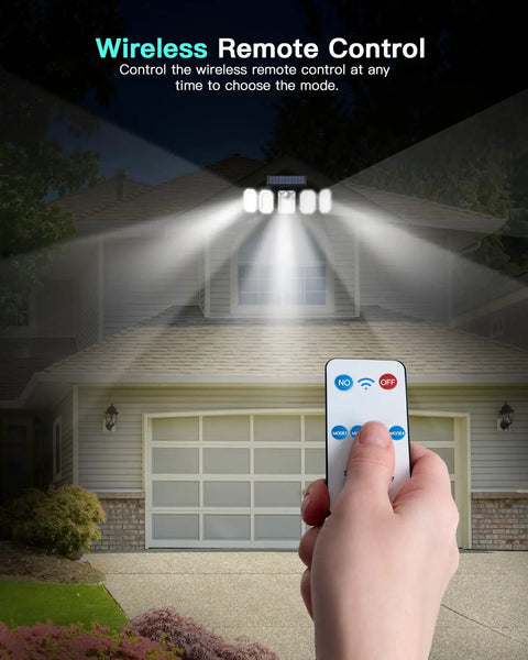 Solar Motion Sensor Lights Outdoor Five Head Flood Light illuminating driveway with remote control against house backdrop.