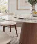 Built Different 53 Inch Round Dining Table Featuring Removable Lazy Susan Gold Ring Faux Marble Top with solid wood base and decor.