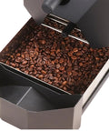 Automatic Electric Air Coffee Bean Roaster With Three Roasting Programs and Nine Professional Baking Curves showing roasted coffee beans in the chaff catcher.