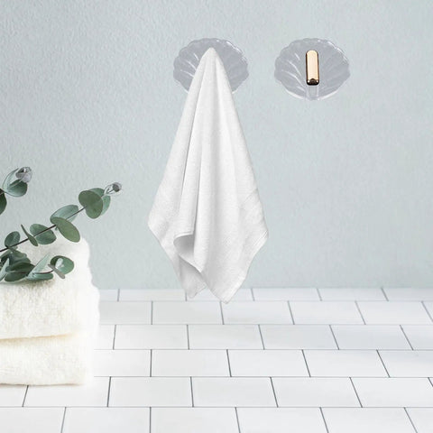 Six Pack Peel And Stick Wall Hooks With Rock Solid Hold For Zero Hassle Bathroom Setup Self Adhesive Hangers For Towels Hats Coats And Everyday Carry holding a white towel.