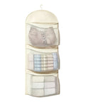 Real Game Changer Three Tier Hanging Closet Organizer With Breathable Mesh Storage Rack For Socks Underwear And Bras Multi Compartment Wardrobe Divider Hassle Free, showing organized socks and underwear in mesh pockets.