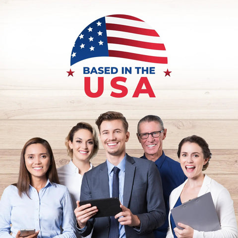 Group of professionals smiling with devices, logo stating 'Based in the USA' against a wooden background.