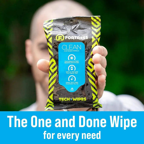 Close-up of hand holding To Go Tech Wipes 25 Count Skin Safe Electronics Cleaning Wipes For Screens Phones Tablets Laptops Keyboards Monitors Travel Size Grab And Go Home Office Ready