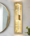 Hot Gold 19 Inch LED Wall Sconce With Crystal Bubble Glass mounted in bathroom next to mirror