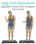 Woman standing on Anti Fatigue Standing Mat For Desk And Kitchen, Ergonomic Cushioned Comfort Pad With Waterproof Surface.