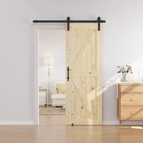 Top Shelf Solid Spruce Wood Sliding Barn Door With Complete Six Foot Track Hardware Unfinished Surface ready for custom staining, in a cozy living space.