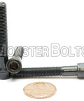 1/4-28 X 1-5/8 Inch Socket Head Cap Screws Heavy Duty Alloy Steel black oxide coated partial thread with a penny for size comparison.