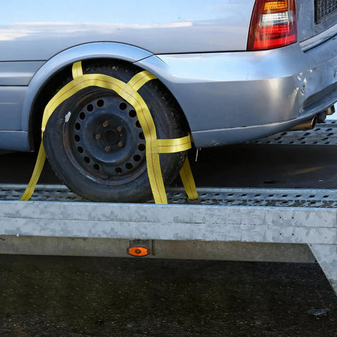 Heavy Duty Tow Dolly Basket Straps Two Pack With Flat Steel Hooks For 15 To 19 Inch Car Tires securing a wheel on a trailer.